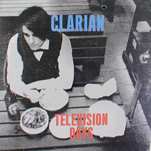 "Black and white vinyl album cover with a man sitting at a picnic."
