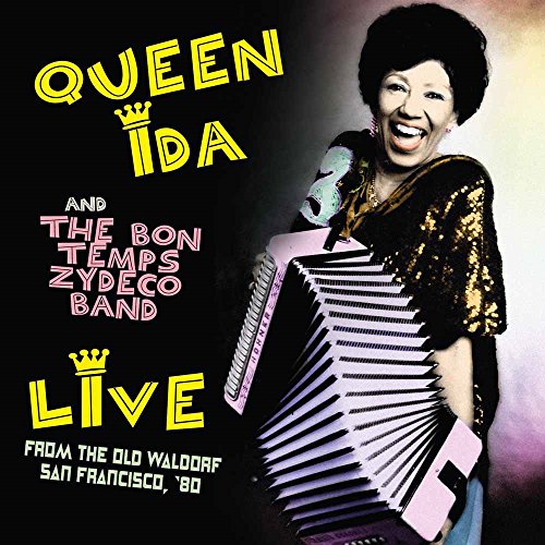 Queen Ida smiling, playing a pink accordion on a black album cover.