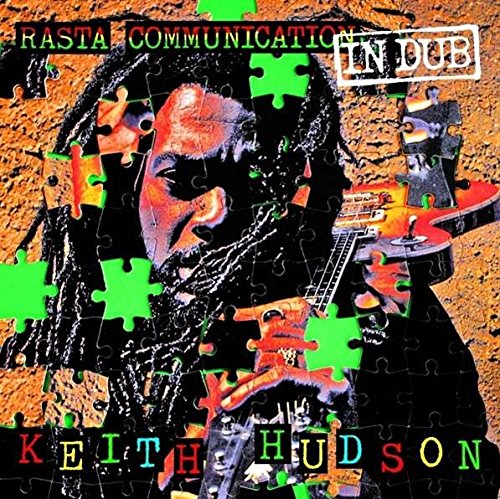 "Album cover with a man holding a guitar, jigsaw puzzle design, multicolored text."