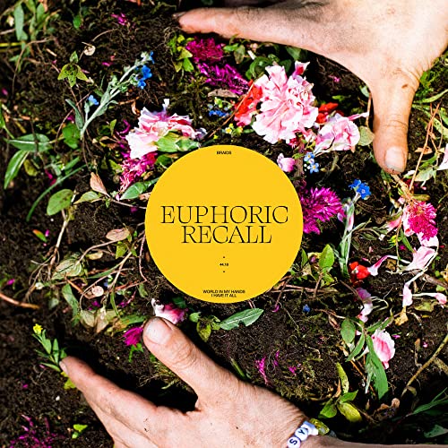 CD album cover with hands framing flowers and soil, yellow circle text.
