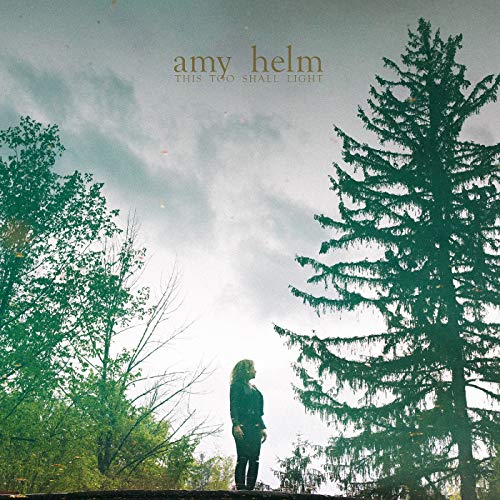 Album cover featuring a woman standing on a log surrounded by trees under a cloudy sky.
