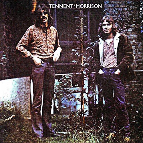 Album cover with two men standing outdoors, wearing casual clothing and long hair.