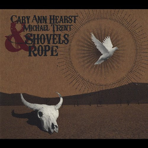 Album cover with text, bird, bull skull, and sunburst design.