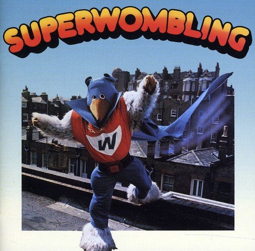 Womble character in red and blue suit, leaping with outstretched arms.