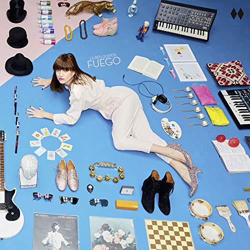 Album cover: woman surrounded by colorful objects on blue background.
