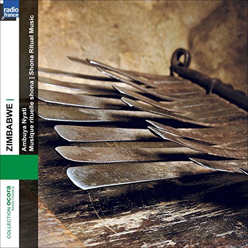 CD cover with a dark, textured background and several metal farm tools.