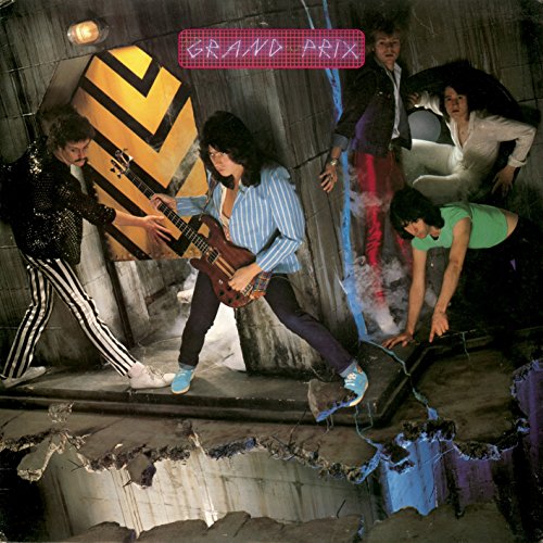 1980s album cover featuring a rock band amidst a fractured, tunnel-like setting.