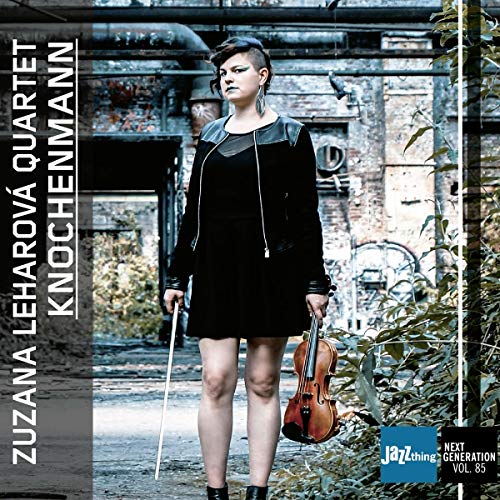 "Album cover featuring a woman holding a violin in an industrial setting."