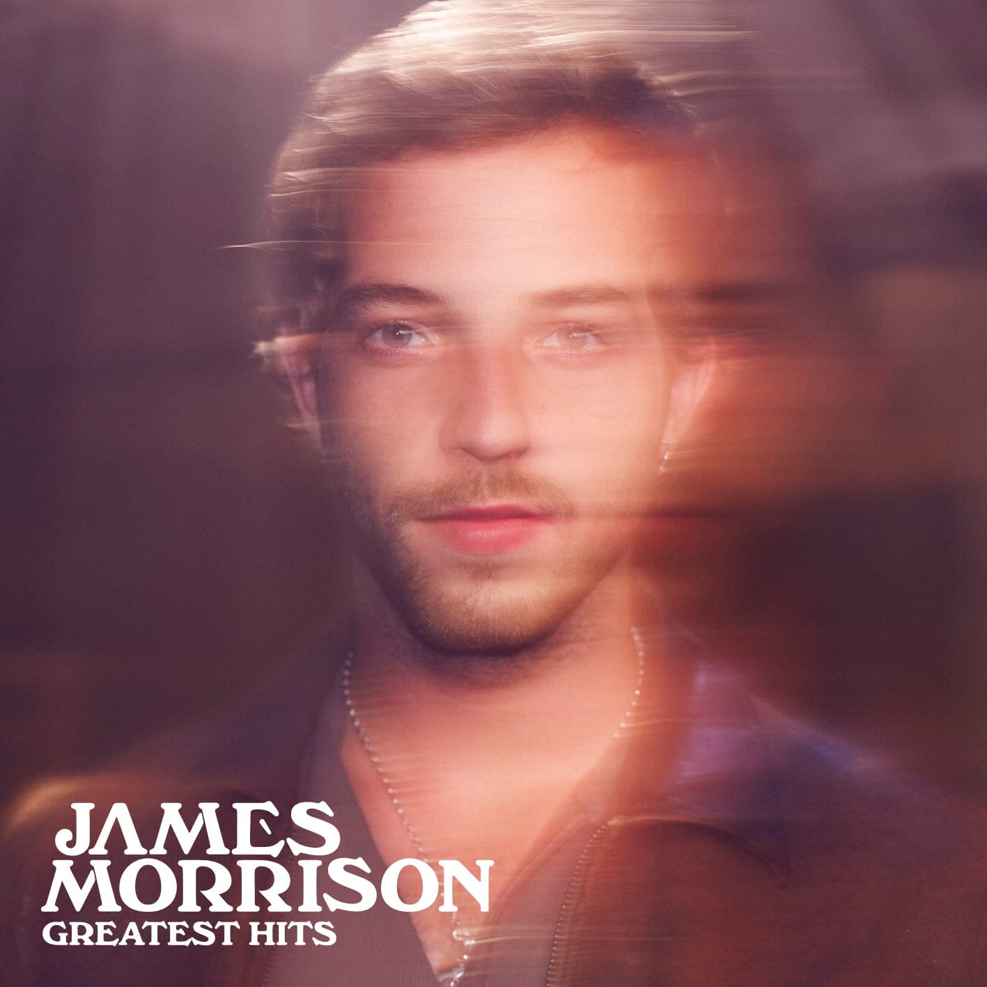 A blurry portrait of James Morrison with text reading James Morrison Greatest Hits.