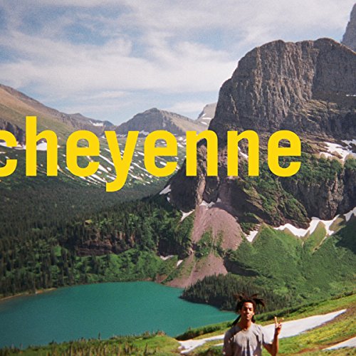 Mountain landscape with text “cheyenne” and a person pointing upwards.