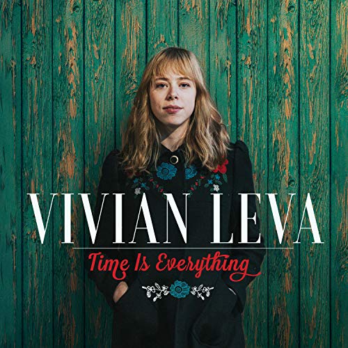 Album cover featuring a woman with long blonde hair against a green wooden background.