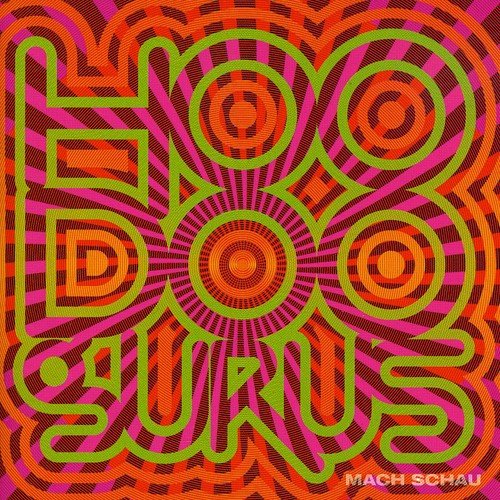 Psychedelic album cover for Hoodoo Gurus’ “Mach Schau” with swirling pink and green text.