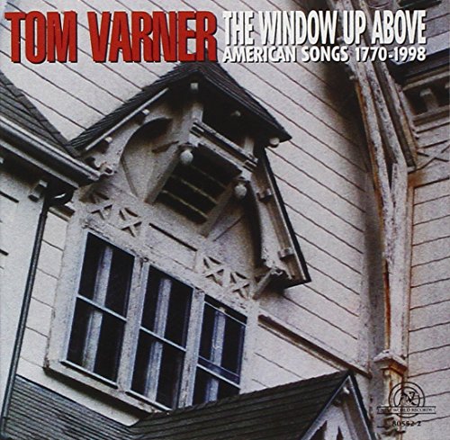 "Album cover featuring a close-up of an old wooden house with ornate window."