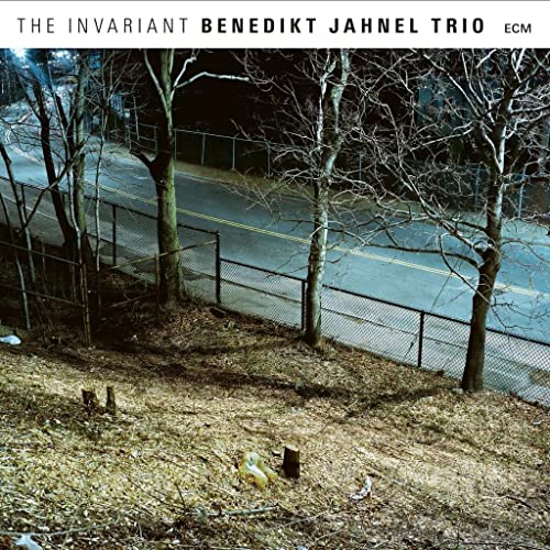 CD cover featuring a nighttime view of a road and bare trees.