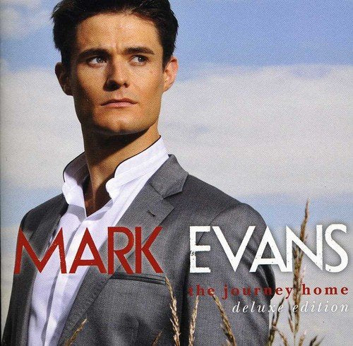 "Album cover featuring a man in a grey suit against a cloudy sky."