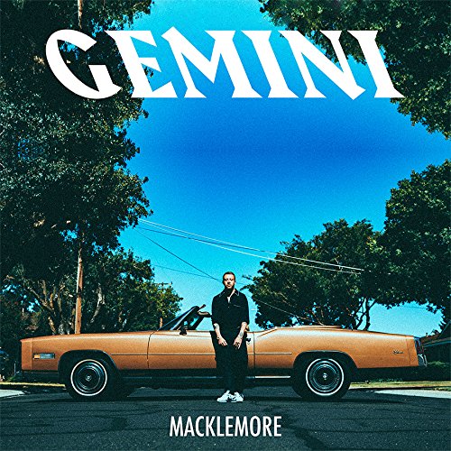 Macklemore album cover: man standing by a vintage orange car under a blue sky.