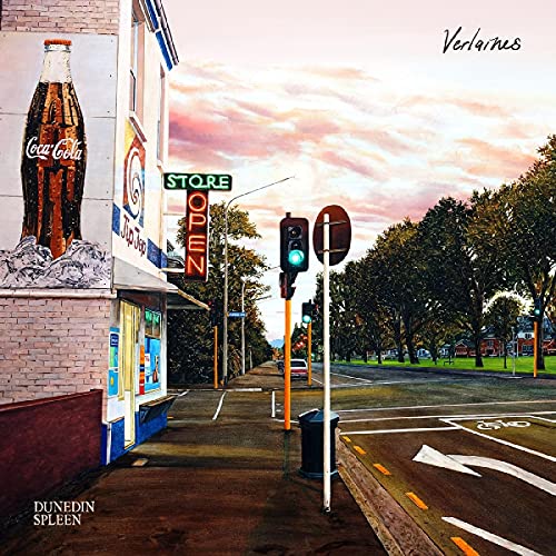 Street scene with a Coca-Cola advertisement, traffic lights, and trees.