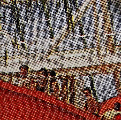 Close-up of halftone patterned CD cover with red and yellow tones.