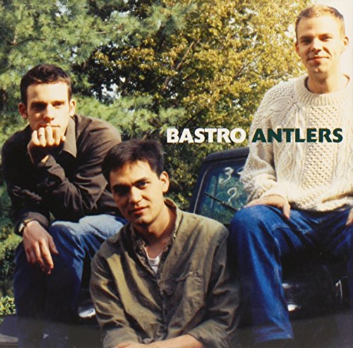 Three men pose outdoors in front of a vehicle, with the text Bastro Antlers overlaid.