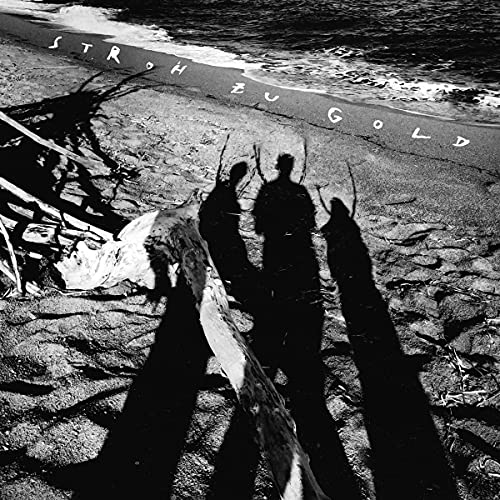 Black and white CD cover with figures and driftwood on a beach.