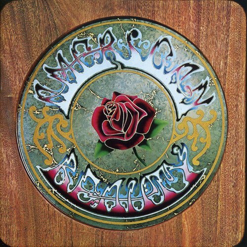 Grateful Dead's "American Beauty" CD cover featuring a red rose on a wooden background.