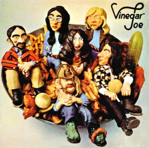 "Album cover featuring a cartoon illustration of five band members sitting on a pickle."
