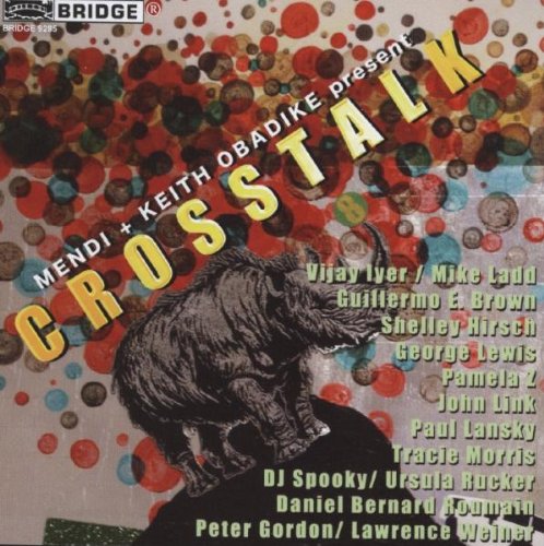 Album cover with black cat and multicolored dots, featuring artist names in yellow text.