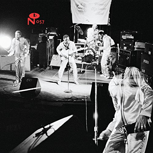 Black and white photo of a band performing on a dimly lit stage.