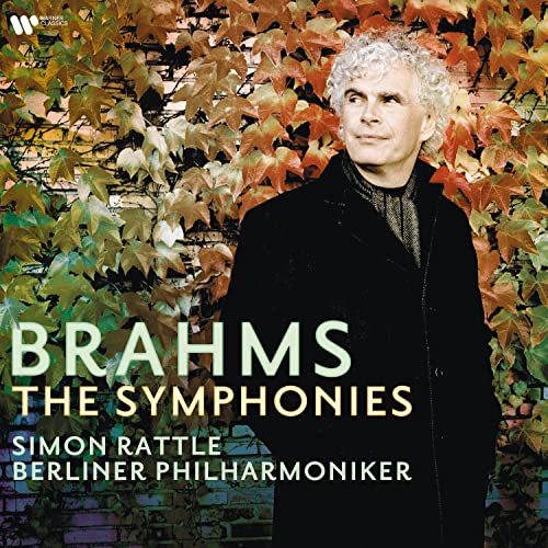 Sir Simon Rattle portrait with autumnal foliage, album cover for Brahms symphonies.