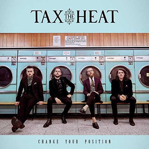 "Album cover featuring four men in suits sitting on blue washing machines."