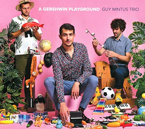"Album cover with three men surrounded by toys against a pink background."