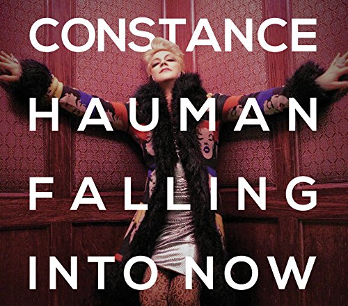 "Album cover featuring a blonde woman in a silver dress against a red paneled wall."