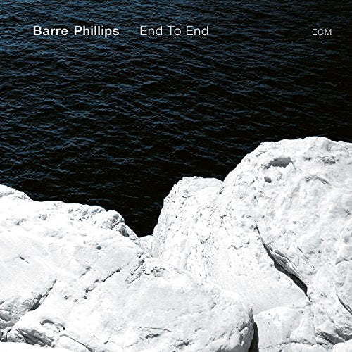 "Album cover featuring white rocks beside dark water, with artist and title in white text."