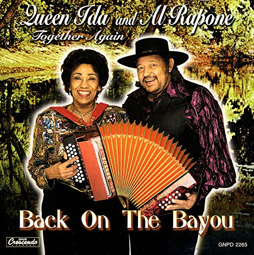 "Album cover featuring a man and woman holding an accordion, bayou background."
