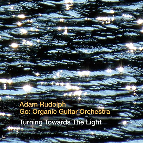 "CD cover with dark water and sunlight reflections, featuring artist and album information."