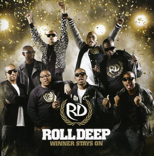 "Album cover featuring seven men in black clothing and sunglasses, surrounded by confetti."