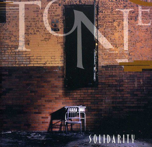 Album cover with a metal chair against a grungy brick wall and "TONE" and "SOLIDARITY" text.