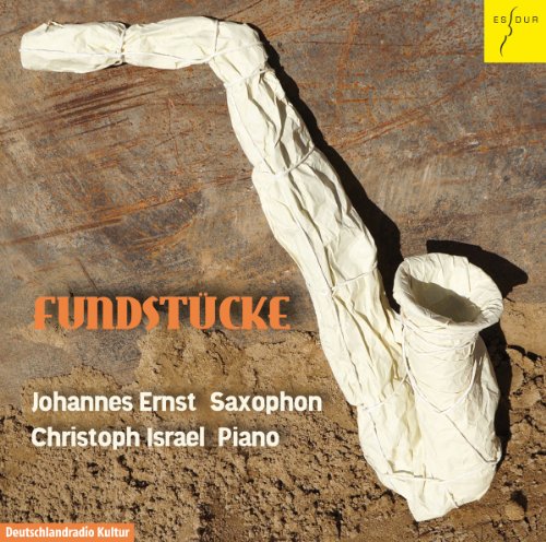 A saxophone wrapped in white cloth lies on the ground, with text overlay.