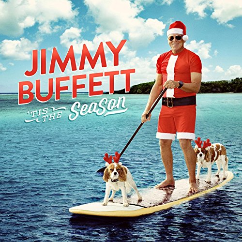 Jimmy Buffett in Santa suit paddleboarding with reindeer dogs.