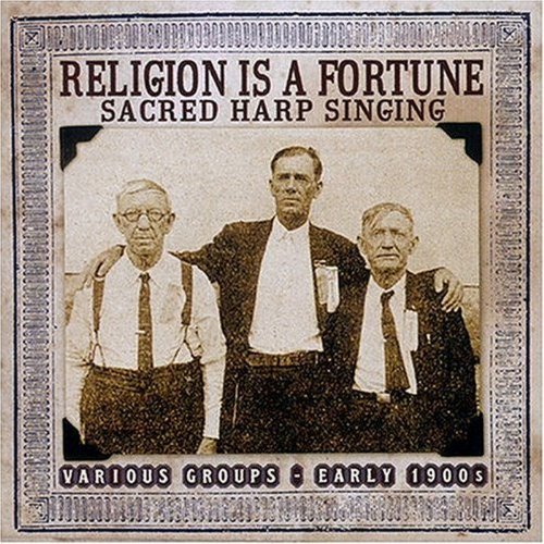 "CD cover with sepia-toned image of three men in suits and a decorative border."