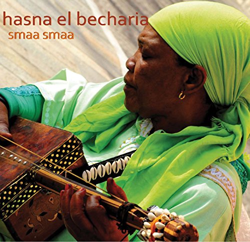 "CD cover featuring a woman in green playing a stringed instrument."