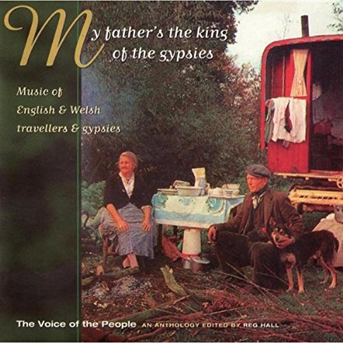 "CD cover with a man, woman, and dogs beside a caravan."