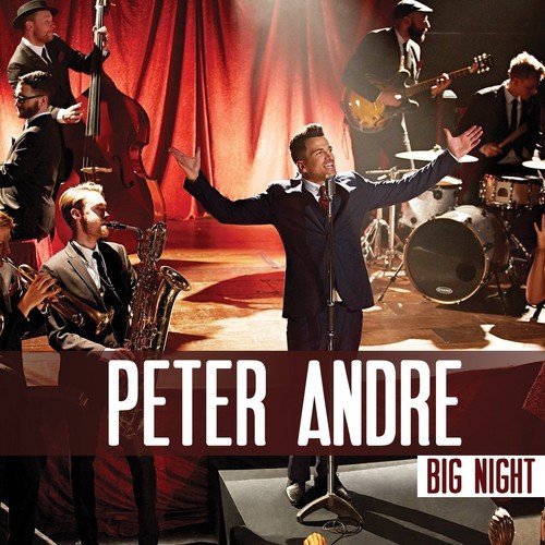 "Album cover featuring a man singing on stage with a band behind him."