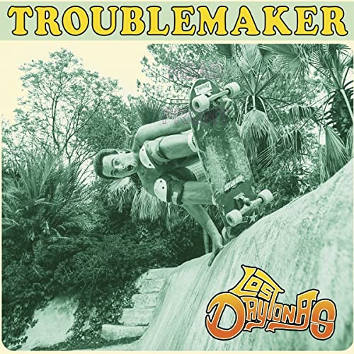 Skateboarder in mid-air against lush greenery, album cover for Los Daytonas.
