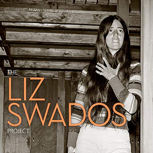 "Black and white album cover with a woman standing by wooden beams."