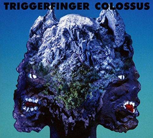"Album cover with a monster head sculpture against a blue-green gradient background."