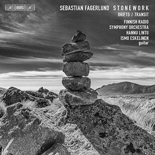 "Black and white album cover with a stack of stones in a rocky landscape."