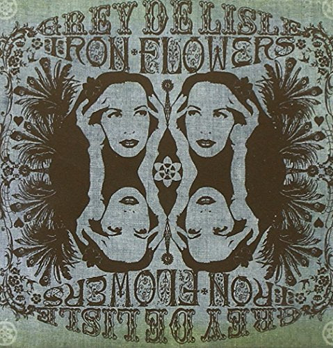 Album cover with symmetrical illustration of a woman's face surrounded by floral designs.