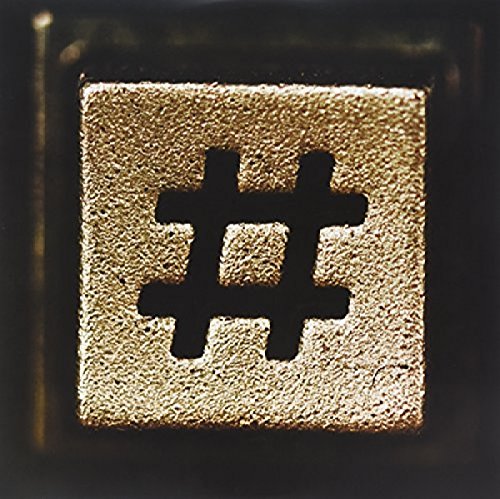 The image depicts a close-up of a keyboard key featuring a hash symbol. Alt text: A gold keyboard key with a black hash symbol on a dark background.