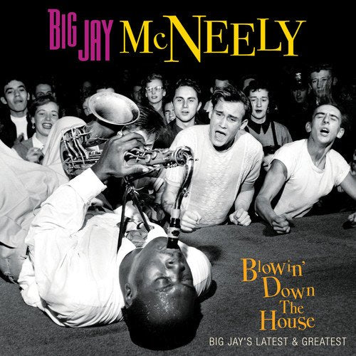"Album cover featuring a man lying on the floor playing a saxophone to a crowd."